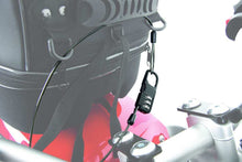 Combination lock with wire rope securing tank bag to bike for theft protection.